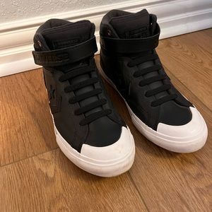 Black and white Converse with strap.